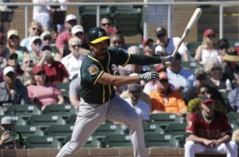 Mar 7, 2017; Salt River Pima-Maricopa, AZ, USA; Oakland Athletics shortstop Marcus Semien (10) hits an RBI single in the second inning against the Arizona Diamondbacks during a spring training game at Salt River Fields at Talking Stick. Mandatory Credit: Rick Scuteri-USA TODAY Sports