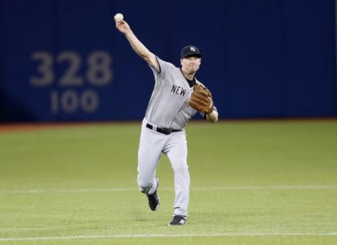 Sep 23, 2015; Toronto, Ontario, CAN; New York Yankees third baseman Chase Headley (12) throws out Toronto Blue Jays shortstop Ryan Goins (not pictured) in the fourth inning at Rogers Centre. Mandatory Credit: John E. Sokolowski-USA TODAY Sports