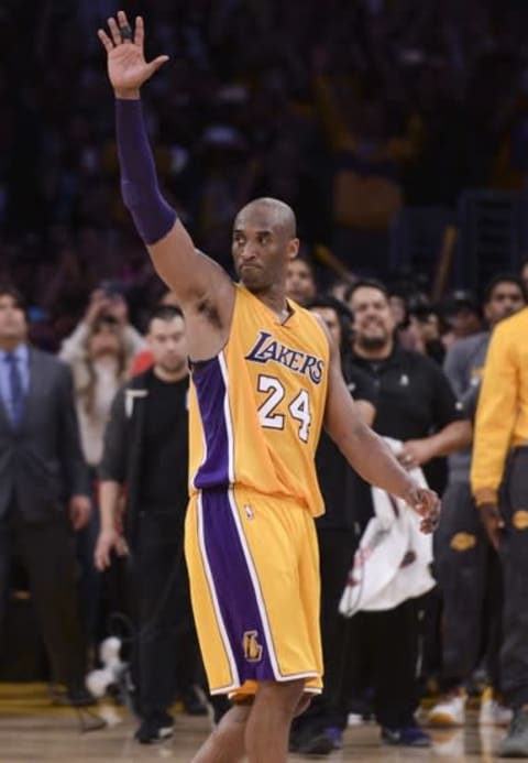 Apr 13, 2016; Los Angeles, CA, USA; Los Angeles Lakers forward Kobe Bryant (24) waves to the crowd as he heads to the bench before the end of the Lakers win over the Utah Jazz at Staples Center. Bryant scored 60 points in the final game of his career. Mandatory Credit: Robert Hanashiro-USA TODAY Sports