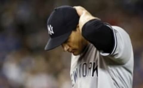 Apr 14, 2016; Toronto, Ontario, CAN; New York Yankees starting pitcher Nathan Eovaldi (30) comes off the field in the fifth inning after giving up three runs to the Toronto Blue Jays at Rogers Centre. Mandatory Credit: John E. Sokolowski-USA TODAY Sports