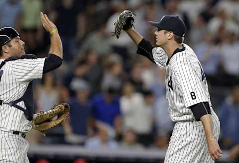 Jun 7, 2016; Bronx, NY, USA; New York Yankees relief pitcher Andrew Miller (48) celebrates with catcher Austin Romine (27) after defeating the Los Angeles Angels at Yankee Stadium. The Yankees won 6-3. Mandatory Credit: Adam Hunger-USA TODAY Sports