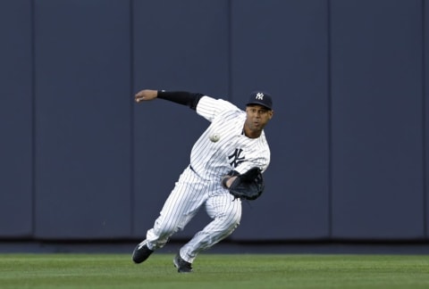 Jun 7, 2016; Bronx, NY, USA; New York Yankees right fielder Aaron Hicks (31) makes an out against the Los Angeles Angels during the first inning at Yankee Stadium. Mandatory Credit: Adam Hunger-USA TODAY Sports