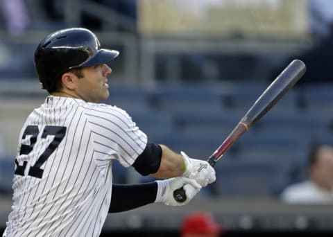 Jun 7, 2016; Bronx, NY, USA; New York Yankees catcher Austin Romine (27) hits an RBI single against the Los Angeles Angels during the first inning at Yankee Stadium. Mandatory Credit: Adam Hunger-USA TODAY Sports