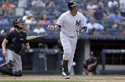 Jun 22, 2016; Bronx, NY, USA; New York Yankees right fielder Carlos Beltran (36) hits a three run home run in front of Colorado Rockies catcher Nick Hundley (4) during the seventh inning of their inter-league game at Yankee Stadium. Mandatory Credit: Adam Hunger-USA TODAY Sports