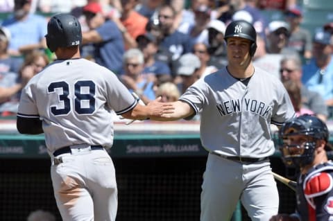 Jul 10, 2016; Cleveland, OH, USA; New York Yankees right fielder Rob Refsnyder (38) and first baseman Mark Teixeira (25) celebrate after Refsnyder scored during the fifth inning against the Cleveland Indians at Progressive Field. Mandatory Credit: Ken Blaze-USA TODAY Sports