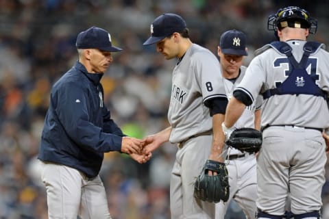 Jul 1, 2016; San Diego, CA, USA; New York Yankees manager Joe Girardi (28) takes the ball from starting pitcher Nathan Eovaldi (center) as he pulls him from the game during the fifth inning against the San Diego Padres at Petco Park. Mandatory Credit: Jake Roth-USA TODAY Sports