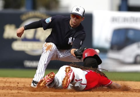 Mar 3, 2016; Tampa, FL, USA; Philadelphia Phillies Jordan Danks (15) slides safely into second as New York Yankees shortstop Tyler Wade (94) drops the ball during the fifth inning at George M. Steinbrenner Field. Mandatory Credit: Butch Dill-USA TODAY Sports