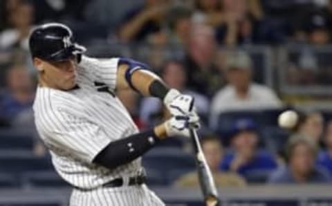 Aug 15, 2016; Bronx, NY, USA; New York Yankees right fielder Aaron Judge (99) hits an RBI double during the fourth inning against the Toronto Blue Jays at Yankee Stadium. Mandatory Credit: Adam Hunger-USA TODAY Sports