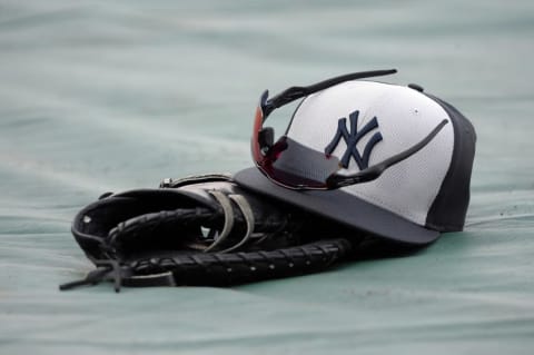 Aug 29, 2016; Kansas City, MO, USA; A New York Yankees hat & glove sit on the field before the game against the Kansas City Royals at Kauffman Stadium. Mandatory Credit: John Rieger-USA TODAY Sports