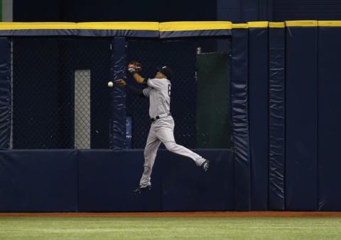 Sep 20, 2016; St. Petersburg, FL, USA; New York Yankees center fielder Mason Williams (66) misses a fly ball during the third inning against the Tampa Bay Rays at Tropicana Field. Mandatory Credit: Kim Klement-USA TODAY Sports