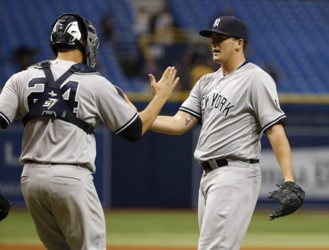 Sep 21, 2016; St. Petersburg, FL, USA; New York Yankees relief pitcher Jonathan Holder (65) and catcher Gary Sanchez (24) congratulate each other after beat the Tampa Bay Rays at Tropicana Field. New York Yankees defeated the Tampa Bay Rays 11-5. Mandatory Credit: Kim Klement-USA TODAY Sports