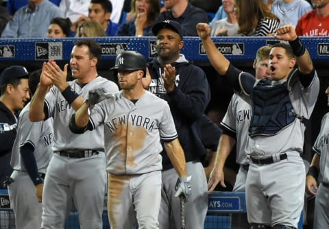 Sep 26, 2016; Toronto, Ontario, CAN; New York Yankees first baseman Mark Teixeira (25), left fielder Brett Gardner(11), pitcher CC Sabathia (52) and catcher Gary Sanchez (24) react to a two-run home run hit by right fielder Aaron Hicks (not pictured) against Toronto Blue Jays in the ninth inning at Rogers Centre. Mandatory Credit: Dan Hamilton-USA TODAY Sports