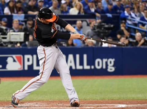 Oct 4, 2016; Toronto, Ontario, CAN; Baltimore Orioles right fielder Mark Trumbo (45) hits a two run home run during the fourth inning against the Toronto Blue Jays in the American League wild card playoff baseball game at Rogers Centre. Mandatory Credit: Nick Turchiaro-USA TODAY Sports