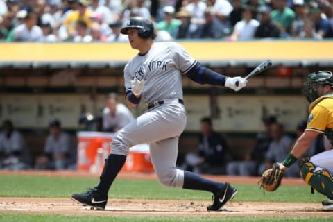 May 31, 2015; Oakland, CA, USA; New York Yankees designated hitter Alex Rodriguez (13) hits a single against the Oakland Athletics during the first inning at O.co Coliseum. Mandatory Credit: Kelley L Cox-USA TODAY Sports