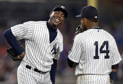 Jul 22, 2016; Bronx, NY, USA; New York Yankees relief pitcher Aroldis Chapman (54) laughs during a break in action with teammate second baseman Starlin Castro (14) during the ninth inning of an inter-league baseball game against the San Francisco Giants at Yankee Stadium. Mandatory Credit: Adam Hunger-USA TODAY Sports