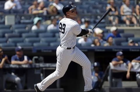 Aug 13, 2016; Bronx, NY, USA; New York Yankees right fielder Aaron Judge (99) watches a solo home run during the second inning against the Tampa Bay Rays at Yankee Stadium. Mandatory Credit: Adam Hunger-USA TODAY Sports