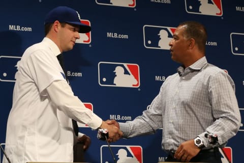 Dec 5, 2016; National Harbor, MD, USA; Los Angeles Dodgers pitcher Rich Hill (left) shakes hands with Dodgers manager Dave Rogers (right) at a press conference announcing Hill