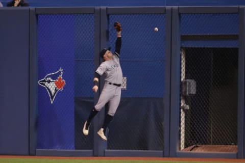 TORONTO, ON – JUNE 05: Clint Frazier #77 of the New York Yankees jumps but cannot reach a two-run home run hit by Randal Grichuk #15 of the Toronto Blue Jays in the first inning during MLB game action at Rogers Centre on June 5, 2019 in Toronto, Canada. (Photo by Tom Szczerbowski/Getty Images)