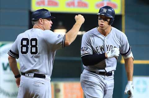 HOUSTON, TEXAS - OCTOBER 13: Aaron Judge #99 of the New York Yankees celebrates with third base coach Phil Nevin #88 after hitting a two-run home run during the fourth inning against the Houston Astros in game two of the American League Championship Series at Minute Maid Park on October 13, 2019 in Houston, Texas. (Photo by Mike Ehrmann/Getty Images)