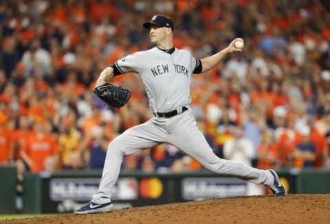 HOUSTON, TEXAS – OCTOBER 13: J.A. Happ #34 of the New York Yankees pitches during the tenth inning against the Houston Astros in game two of the American League Championship Series at Minute Maid Park on October 13, 2019 in Houston, Texas. (Photo by Bob Levey/Getty Images)