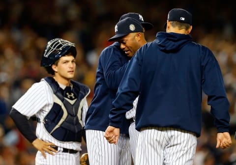 NEW YORK, NY – SEPTEMBER 26: (NEW YORK DAILIES OUT) Mariano Rivera #42 of the New York Yankees fights back tears as he is removed from a game against the Tampa Bay Rays in the ninth inning by teammates Derek Jeter #2 and Andy Pettitte #46 (R) as catcher J.R. Murphy #66 looks on at Yankee Stadium on September 26, 2013 in the Bronx borough of New York City. The Rays defeated the Yankees 4-0. (Photo by Jim McIsaac/Getty Images)