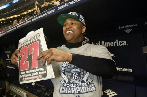 NEW YORK - NOVEMBER 04: C.C. Sabathia of the New York Yankees celebrates in the dugout with a copy of the New York Post after their 7-3 win against the Philadelphia Phillies in Game Six of the 2009 MLB World Series at Yankee Stadium on November 4, 2009 in the Bronx borough of New York City. (Photo by Nick Laham/Getty Images)