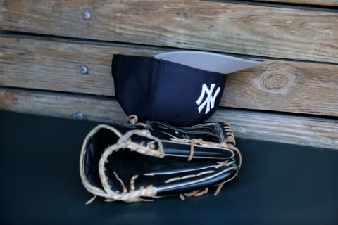 BALTIMORE, MD – APRIL 13: A New York Yankees glove and hat sit in the dugout before the start of the Yankees and Baltimore Orioles game at Oriole Park at Camden Yards on April 13, 2015 in Baltimore, Maryland. (Photo by Rob Carr/Getty Images)