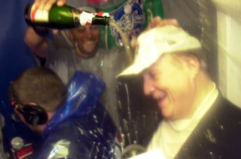 26 Oct 2000: Derek Jeter of the New York Yankees pours champagne over the head of team owner George Steinbrenner in the locker room after the Yankees 4-2 win over the New York Mets of Game 5 of the World Series at Shea Stadium in Flushing, New York.  Mandatory Credit: Ezra Shaw/ALLSPORT