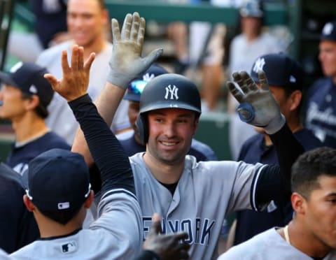 ARLINGTON, TX – MAY 23: Neil Walker #14 of the New York Yankees gets high fives in the dugout after a home run in the third inning of a baseball game against the Texas Rangers at Globe Life Park in Arlington on May 23, 2018 in Arlington, Texas. (Photo by Richard Rodriguez/Getty Images)