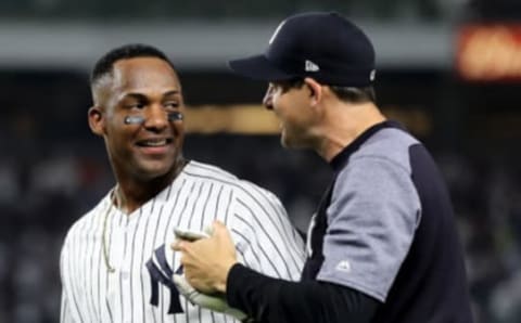 New York Yankee Miguel Andujar #41 is congratulated by manager Aaron Boone #17 (Photo by Elsa/Getty Images)