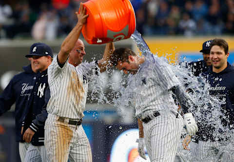 NEW YORK, NY – MAY 12: Brett Gardner #11 of the New York Yankees douses teammate Neil Walker #14 after his eleventh inning game winning base hit against the Oakland Athletics at Yankee Stadium on May 12, 2018 in the Bronx borough of New York City. (Photo by Jim McIsaac/Getty Images)