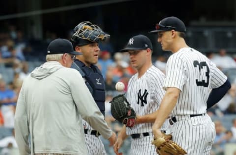 NEW YORK, NY – AUGUST 1: Pitching coach Larry Rothschild, catcher Austin Romine #28 and Greg Bird #33 talk with pitcher Sonny Gray #55 of the New York Yankees on the mound in an MLB baseball game against the Baltimore Orioles on August 1, 2018 at Yankee Stadium in the Bronx borough of New York City. Orioles won 7-5. (Photo by Paul Bereswill/Getty Images)