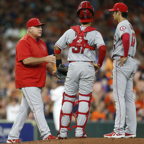 HOUSTON, TX – SEPTEMBER 02: Manager Mike Scioscia #14 of the Los Angeles Angels of Anaheim takes the ball from Shohei Ohtani #17 in the third inning Francisco Arcia #37 looks on against the Houston Astros at Minute Maid Park on September 2, 2018 in Houston, Texas. (Photo by Bob Levey/Getty Images)