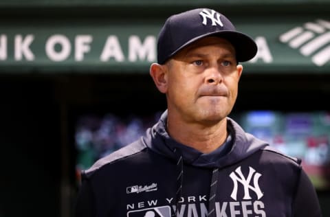 Manager Aaron Boone of the New York Yankees looks on from the dugout before a game against the Boston Red Sox at Fenway Park on September 6, 2019 in Boston, Massachusetts. (Photo by Adam Glanzman/Getty Images)