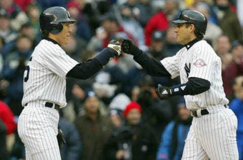 Hideki Matsui (L) of the New York Yankees congratulates teammate Robin Ventura after Ventura hit a two-run home run against the Minnesota Twins 08 April, 2003, at Yankees Stadium in the Bronx. AFP PHOTO/Don EMMERT (Photo by Don EMMERT / AFP) (Photo by DON EMMERT/AFP via Getty Images)