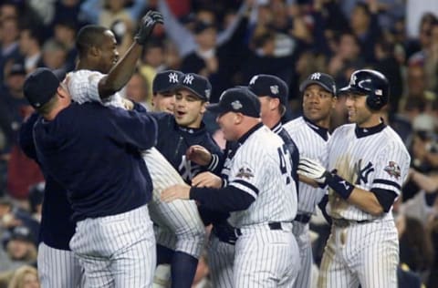 New York Yankees 2nd baseman Alfonso Soriano is hoisted up by his teammates after he hit in the game winning run in the bottom of the 12th inning of Game 5 of the World Series at Yankee Stadium in New York 01 November, 2001. The Yankees defeated the Arizona Diamondbacks 3-2 and took a lead of 3-2 in the series. AFP PHOTO/Timothy A. CLARY (Photo by Timothy A. CLARY / AFP) (Photo by TIMOTHY A. CLARY/AFP via Getty Images)