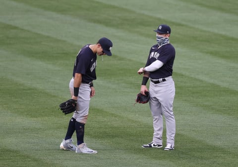 Mike Tauchman #39 of the New York Yankees spits while talking to Clint Frazier #77 of the New York Yankees (Photo by Al Bello/Getty Images)