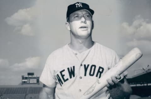 UNSPECIFIED – UNDATED: Mickey Mantle poses for the camera with bat in hand in this undated photo. (Photo by Sports Studio Photos/Getty Images)