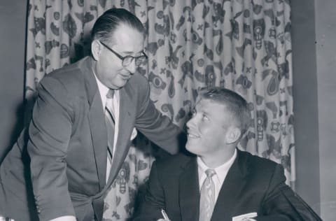 UNSPECIFIED - UNDATED: Mickey Mantle signing his new contract with Yankee executive Bill DeWitt in this undated photo. (Photo by Sports Studio Photos/Getty Images)