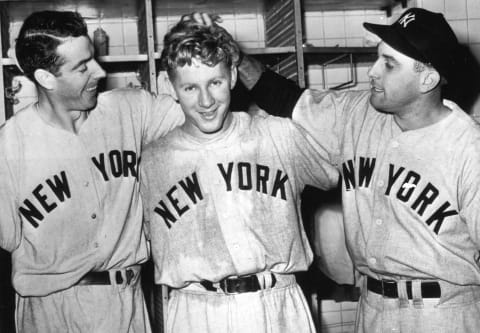 Whitey Ford, center is congratulated by Joe DiMaggio, left, and Gene Woodling (Photo by Mark Rucker/Transcendental Graphics, Getty Images)