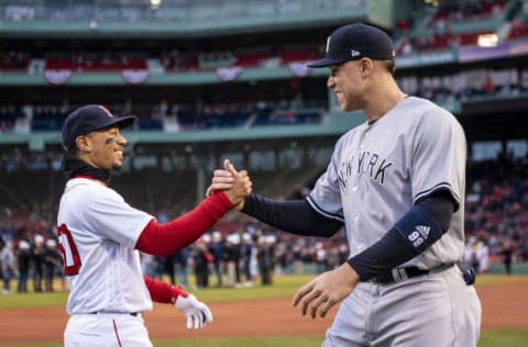 Mookie Betts #50 of the Boston Red Sox high fives Aaron Judge #99 of the New York Yankees (Photo by Billie Weiss/Boston Red Sox/Getty Images)