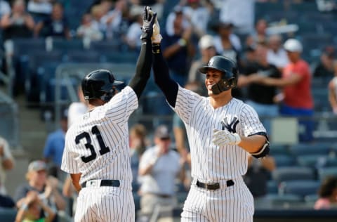 NEW YORK, NY - AUGUST 16: (NEW YORK DAILIES OUT) Giancarlo Stanton #27 and Aaron Hicks #31 of the New York Yankees in action against the Tampa Bay Rays at Yankee Stadium on August 16, 2018 in the Bronx borough of New York City. The Rays defeated the Yankees 3-1. (Photo by Jim McIsaac/Getty Images)