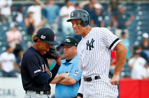 NEW YORK, NY - AUGUST 18: Francisco Lindor #12 of the Cleveland Indians laughs as he walks over to Aaron Judge #99 of the New York Yankees after Judge celebrated hitting an rbi double by mimicking Brett Gardner, who was ejected yesterday after pounding a bat on the dugout ceiling, as umpire Todd Tichenor #13 looks away in an MLB baseball game against on August 18, 2019 at Yankee Stadium in the Bronx borough of New York City. Cleveland won 8-4. (Photo by Paul Bereswill/Getty Images)