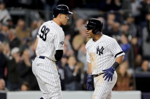 NEW YORK, NEW YORK - OCTOBER 04: Aaron Judge #99 and Edwin Encarnacion #30 of the New York Yankees celebrate after scoring off of a RBI single hit by Gleyber Torres #25 against Jose Berrios #17 of the Minnesota Twins during the third inning in game one of the American League Division Series at Yankee Stadium on October 04, 2019 in New York City. (Photo by Elsa/Getty Images)