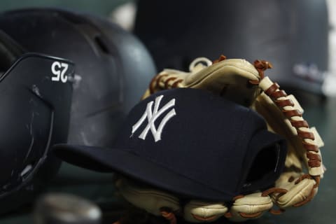 A New York Yankees hat and glove (Photo by Tim Warner/Getty Images)