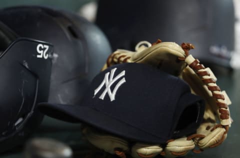 A New York Yankees hat and glove (Photo by Tim Warner/Getty Images)