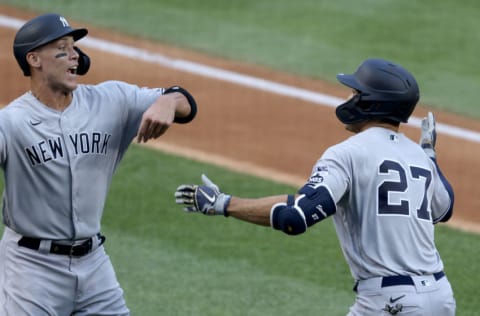 WASHINGTON, DC - JULY 23: Giancarlo Stanton #27 of the New York Yankees celebrates with Aaron Judge #99 after hitting a two run home run to center field against Max Scherzer #31 of the Washington Nationals during the first inning in the game at Nationals Park on July 23, 2020 in Washington, DC. (Photo by Rob Carr/Getty Images)