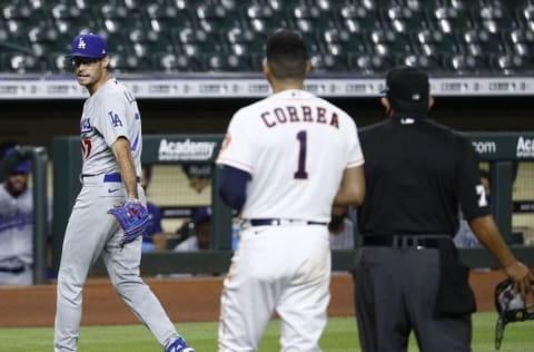 HOUSTON, TEXAS - JULY 28: Joe Kelly #17 of the Los Angeles Dodgers has a word with Carlos Correa #1 of the Houston Astros as he walks off the mound after a series of high inside pitches in the sixth inning at Minute Maid Park on July 28, 2020 in Houston, Texas. Both benches emptied. (Photo by Bob Levey/Getty Images)