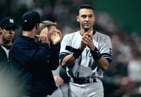 Derek Jeter #2 of the New York Yankees cheers during the ALCS game two against the Boston Red Sox at Fenway Park in Boston, Massacusetts. The Yankees defeated the Red Sox 9-2. Mandatory Credit: Jonathan Daniel /Allsport