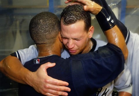 Alex Rodriguez #13 (R) hugs teammate Gary Sheffield #11 of the New York Yankees during a locker room celebration after defeating the Minnesota Twins (Photo by Jed Jacobsohn/Getty Images)